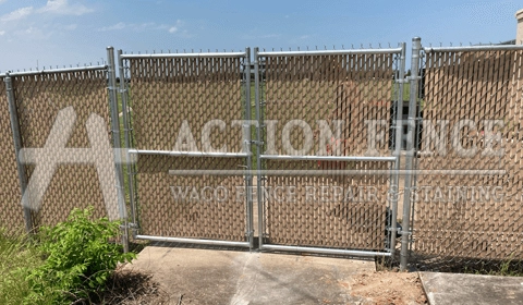 Commercial chain-link fence with double-drive gate and privacy slats