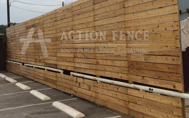 Horizontal commercial privacy fence in parking lot