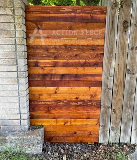 Natural-tone stained cedar fence